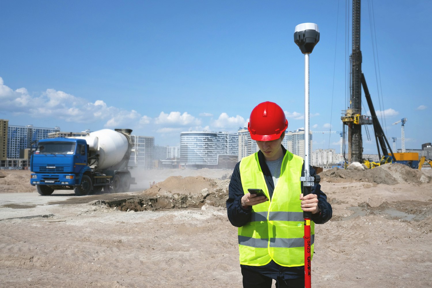 A field worker using a device on site Worker using a handheld device on a construction site